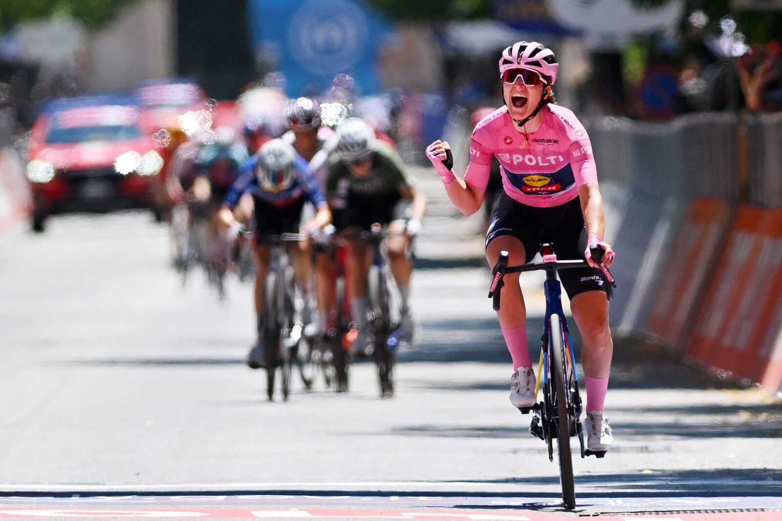 Cyclist celebrating at the finish line, showing strong endurance and effective fueling strategy to avoid bonking during a race