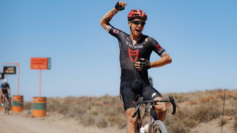 Swiss rider Simon Pellaud celebrates crossing the line as he wins Stage 3 of the Nedbank Gravel Burn.