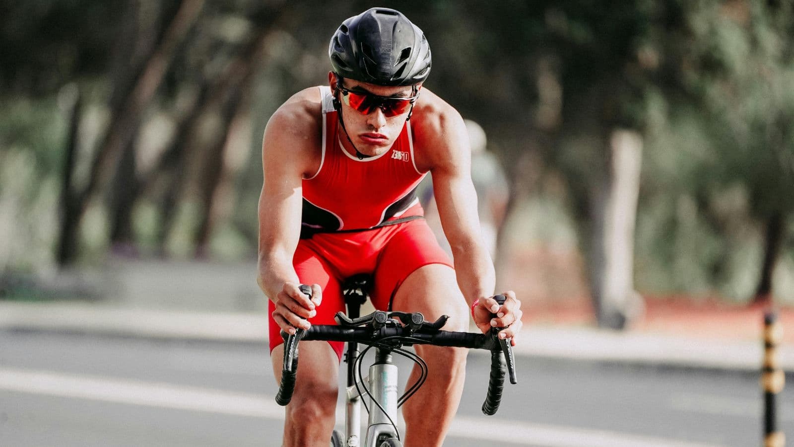 Cyclist riding at steady pace during training, maintaining controlled Zone 2 effort for endurance