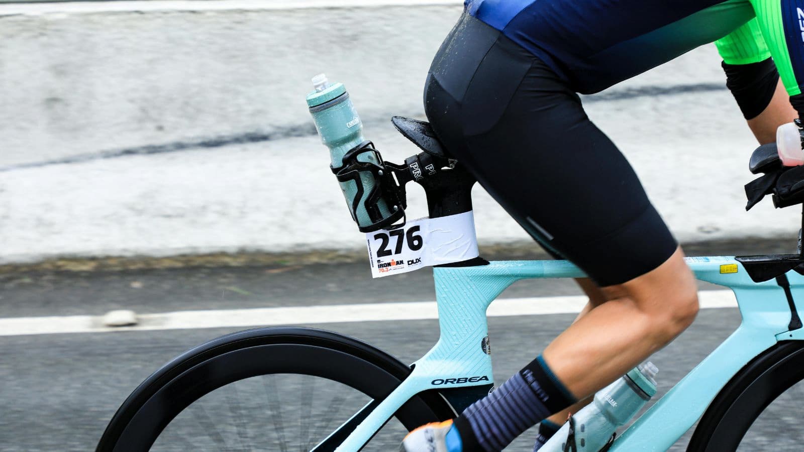 Cyclist riding with electrolyte bottle mounted on bike, supporting hydration and endurance performance