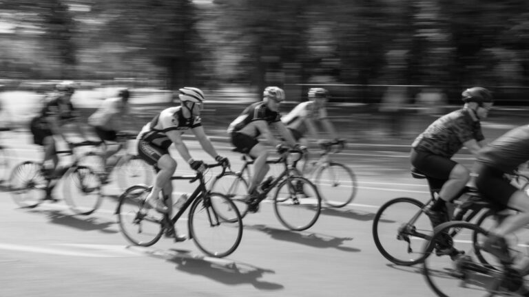 Group of beginner cyclists riding together in a race, maintaining steady pace and control