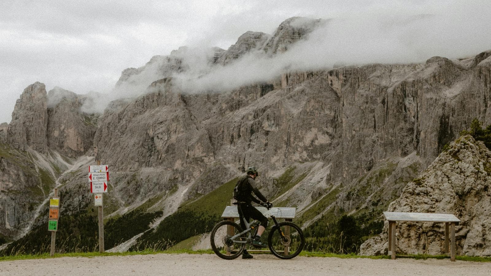 cyclist descending steep road confidently with proper body position and bike control