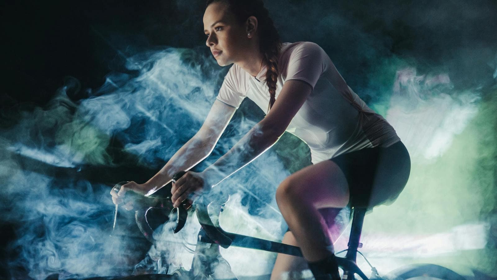 cyclist riding indoors on trainer and doing endurance workout during off season