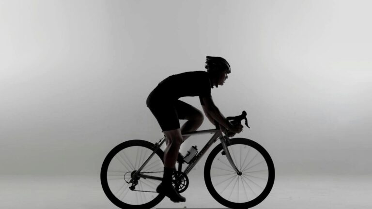 athlete doing mobility exercises for hips and hamstrings to improve cycling comfort and flexibility