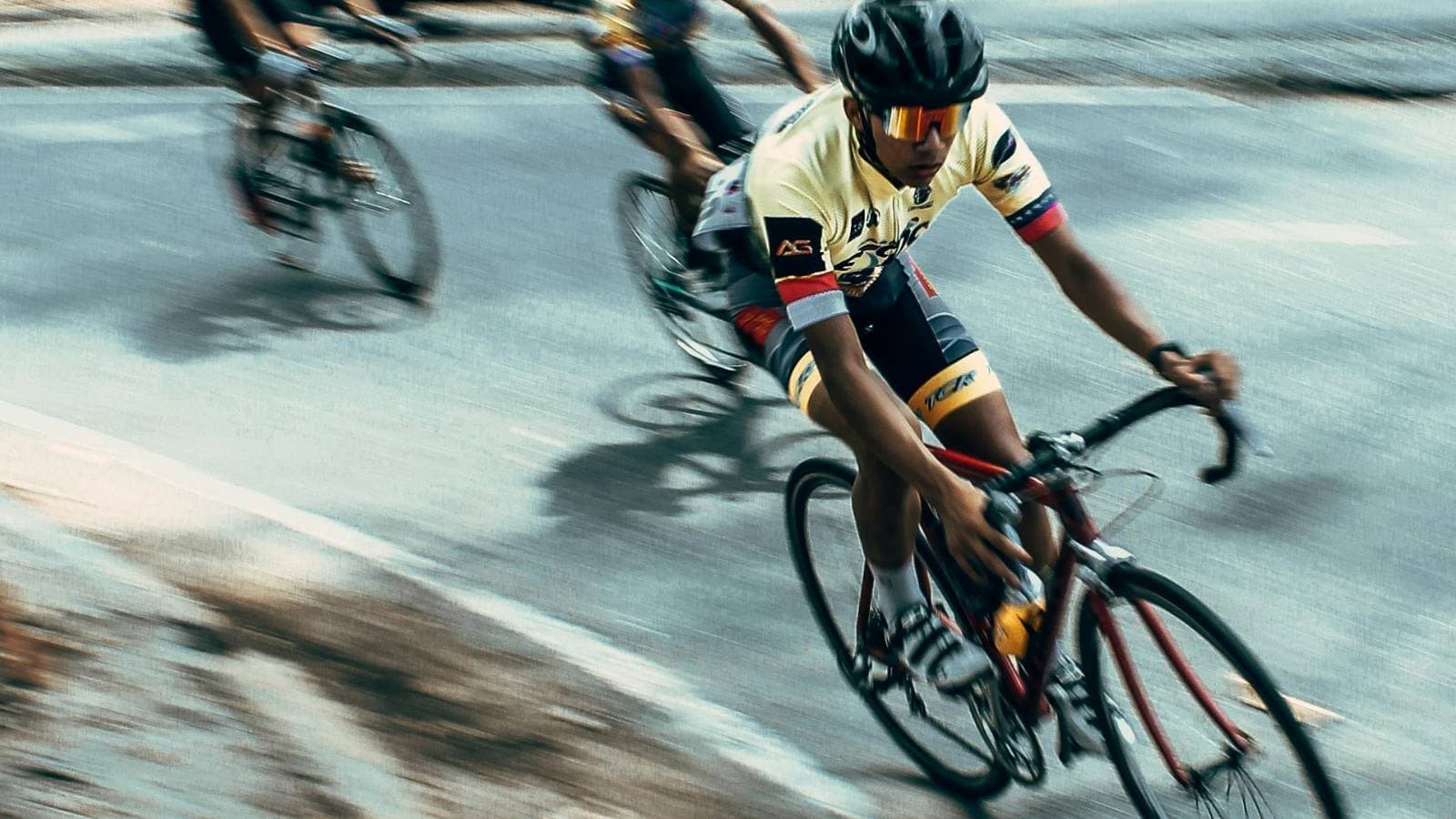 beginner cyclist practicing cornering technique on road bike focusing on balance and control during a turn