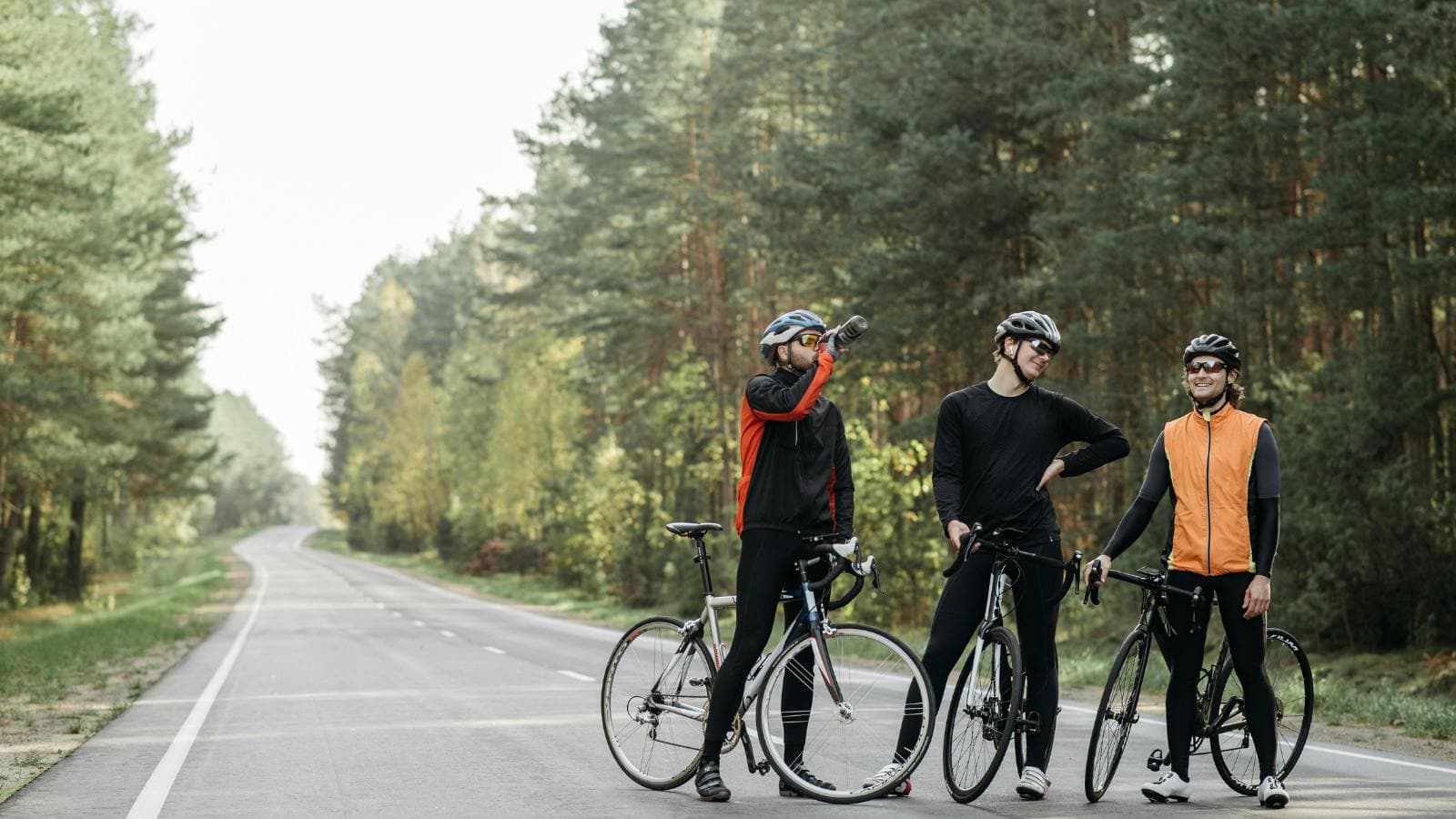 road cyclist using sports drink and snacks to fuel during 2 hour cycling training session