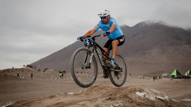 cyclist alternating between seated and standing climbing positions to handle varying gradients on hill