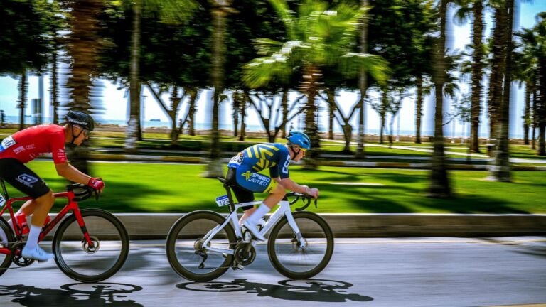 Multiple cyclists sprinting during a road race, showcasing power, speed, and competitive intensity.