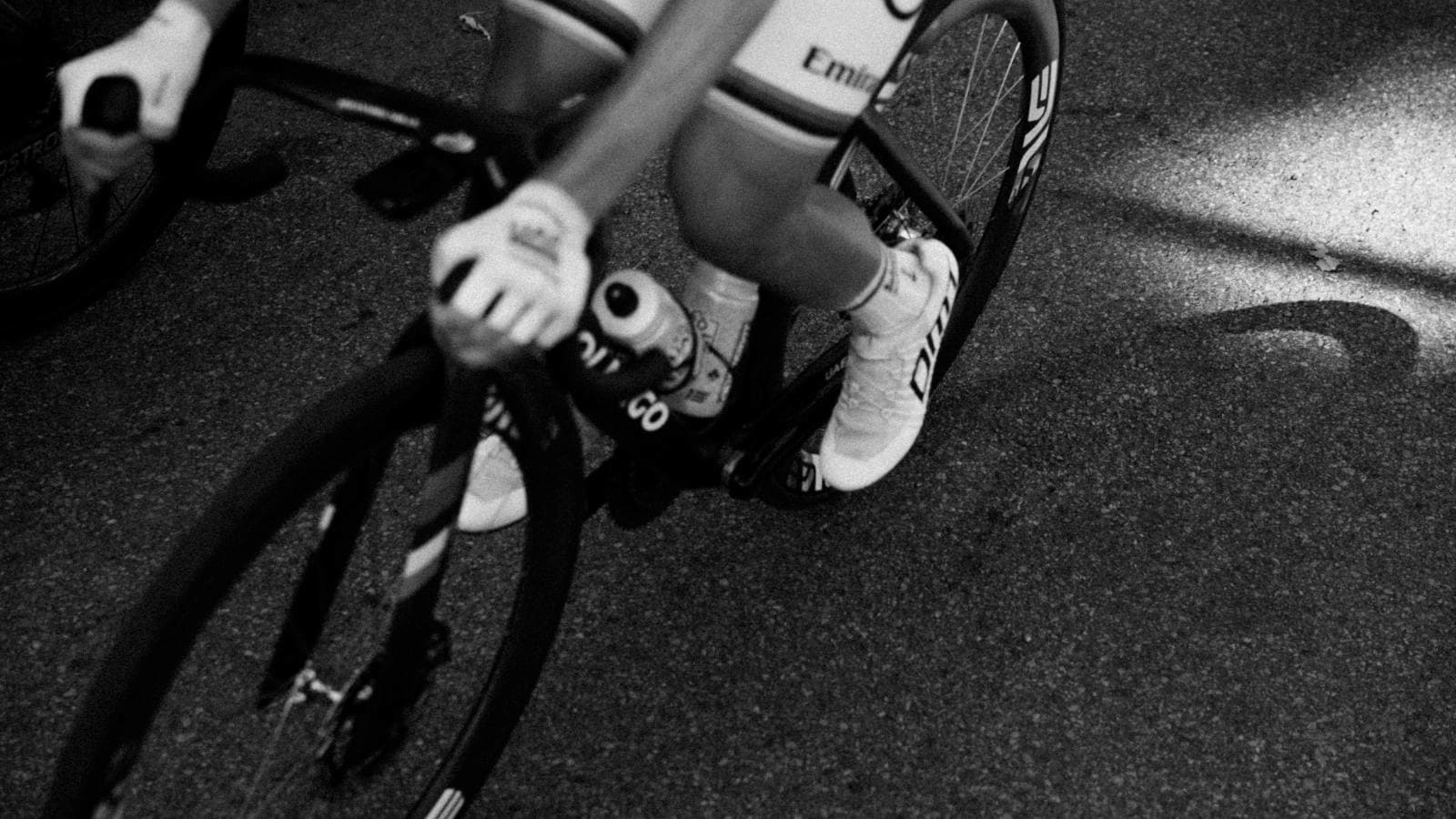 athlete practicing nutrition strategy with gels and sports drink to improve carb absorption while cycling