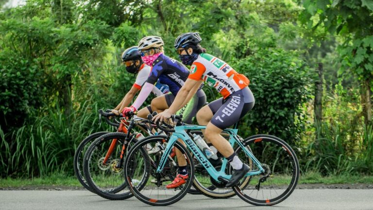 Experienced road cyclist riding at a relaxed pace with slower cyclists during an easy group endurance ride.
