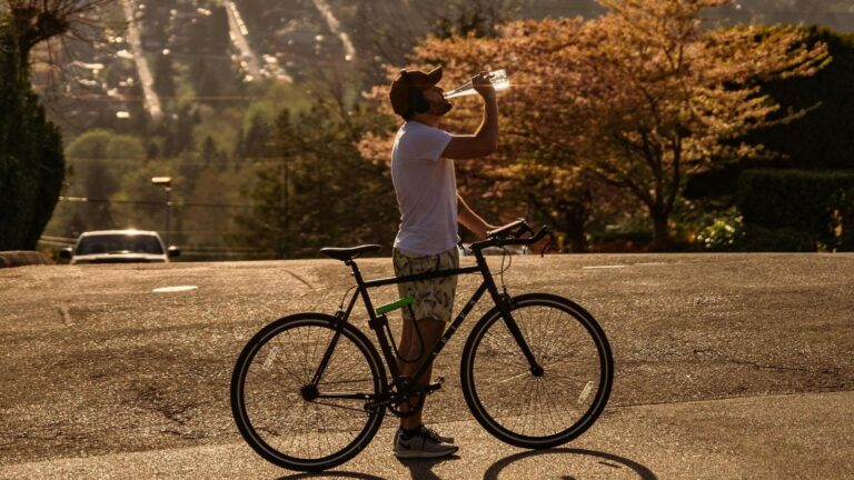 cyclist consuming energy gels during ride to train gut for higher carbohydrate intake and endurance