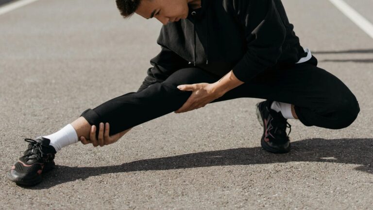 cyclist performing dynamic warm up exercises before bike race to improve performance and mobility