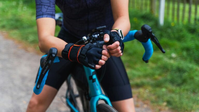 cyclist adjusting riding position to reduce hand numbness and saddle discomfort during long ride