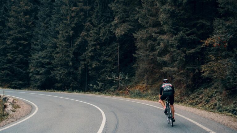 road cyclist descending mountain road using safe braking and cornering techniques