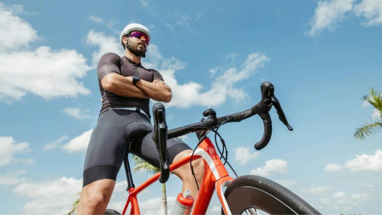 cyclist experiencing fatigue and muscle soreness from excessive cycling training and poor recovery