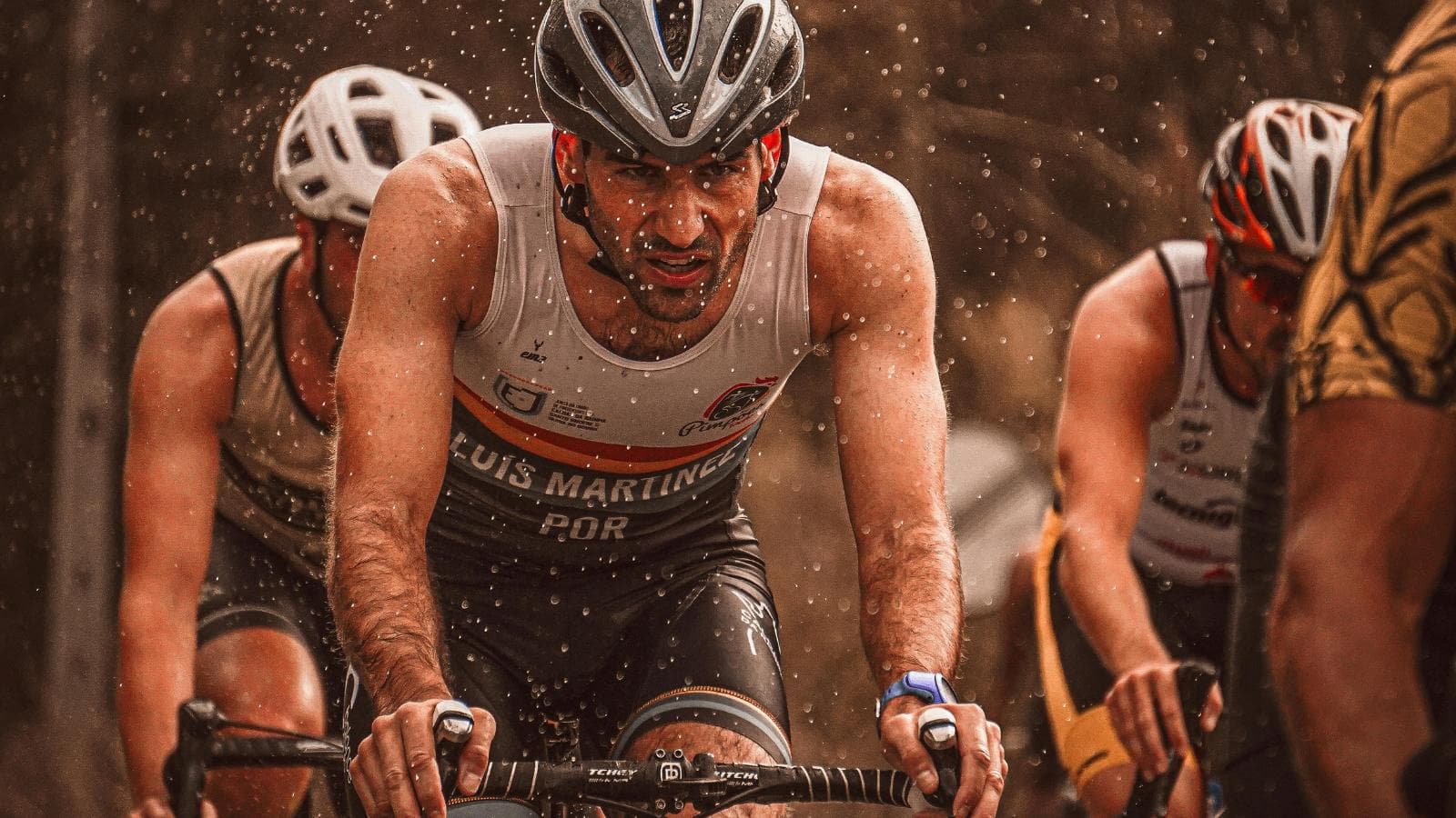 cyclist riding safely in rainy weather with wet roads and protective cycling gear