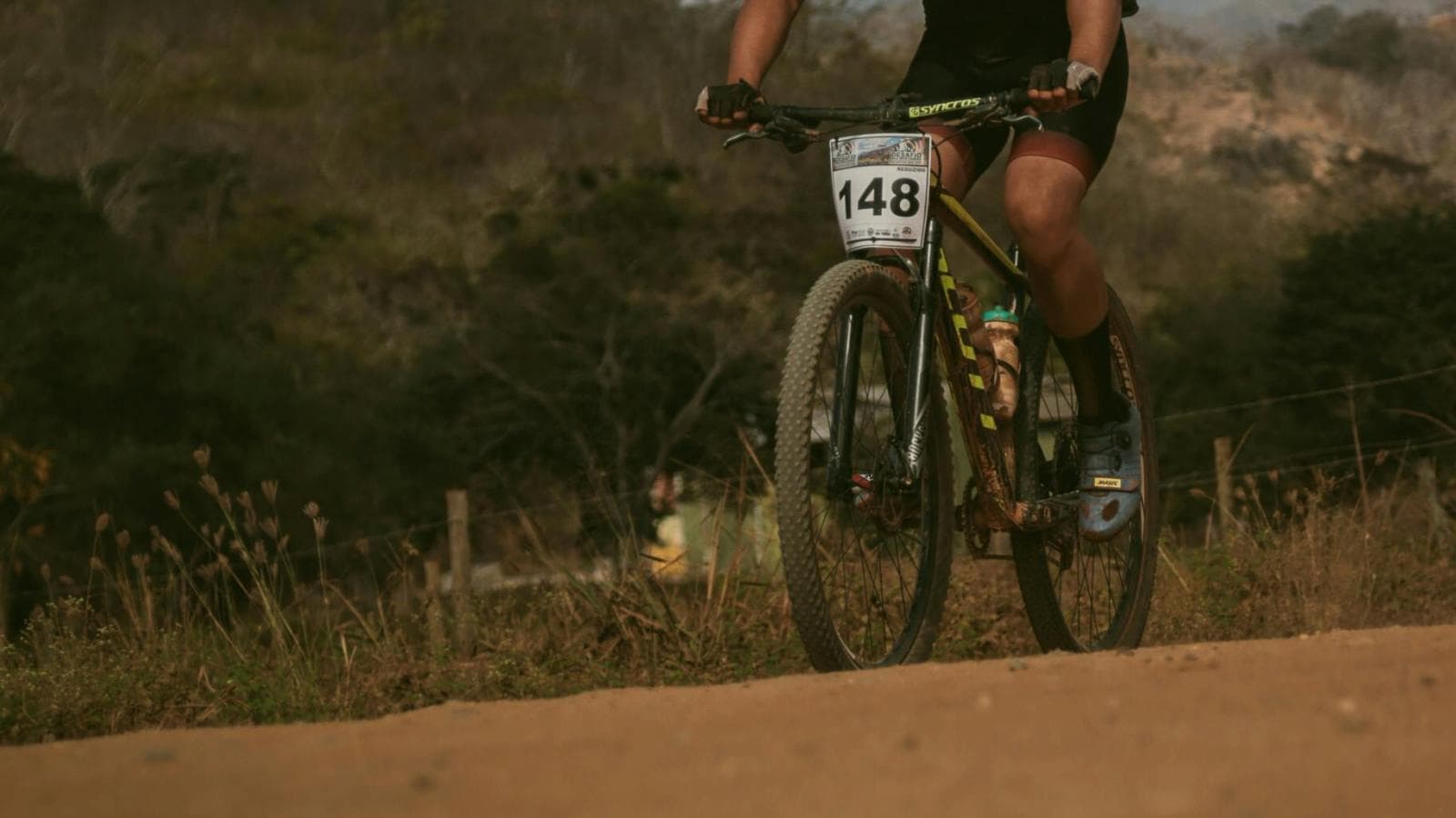 beginner mountain biker riding on forest trail while learning off road cycling skills