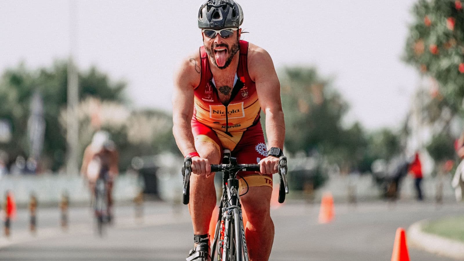 Road cyclist accelerating from a steady pace during a structured cycling training session.