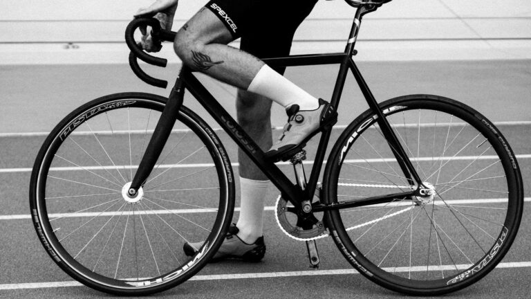 cyclist inspecting bike equipment to avoid common gear mistakes before training ride