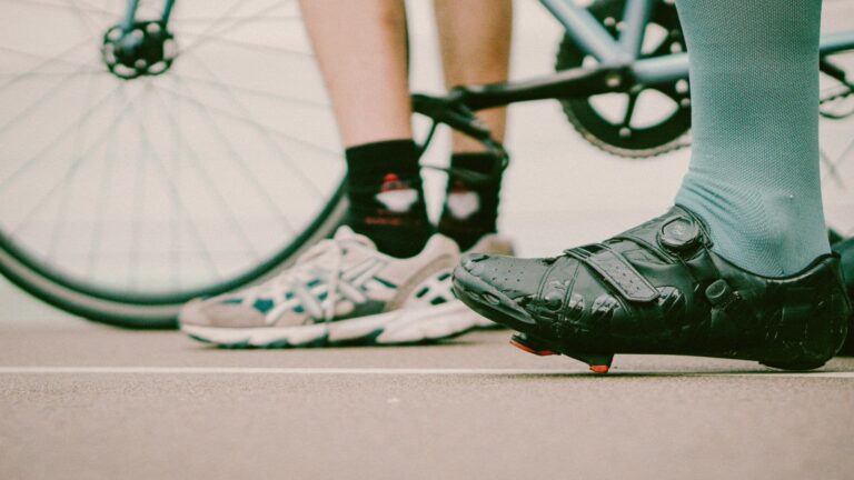 cyclist experiencing hot foot and foot discomfort during a long distance bike ride