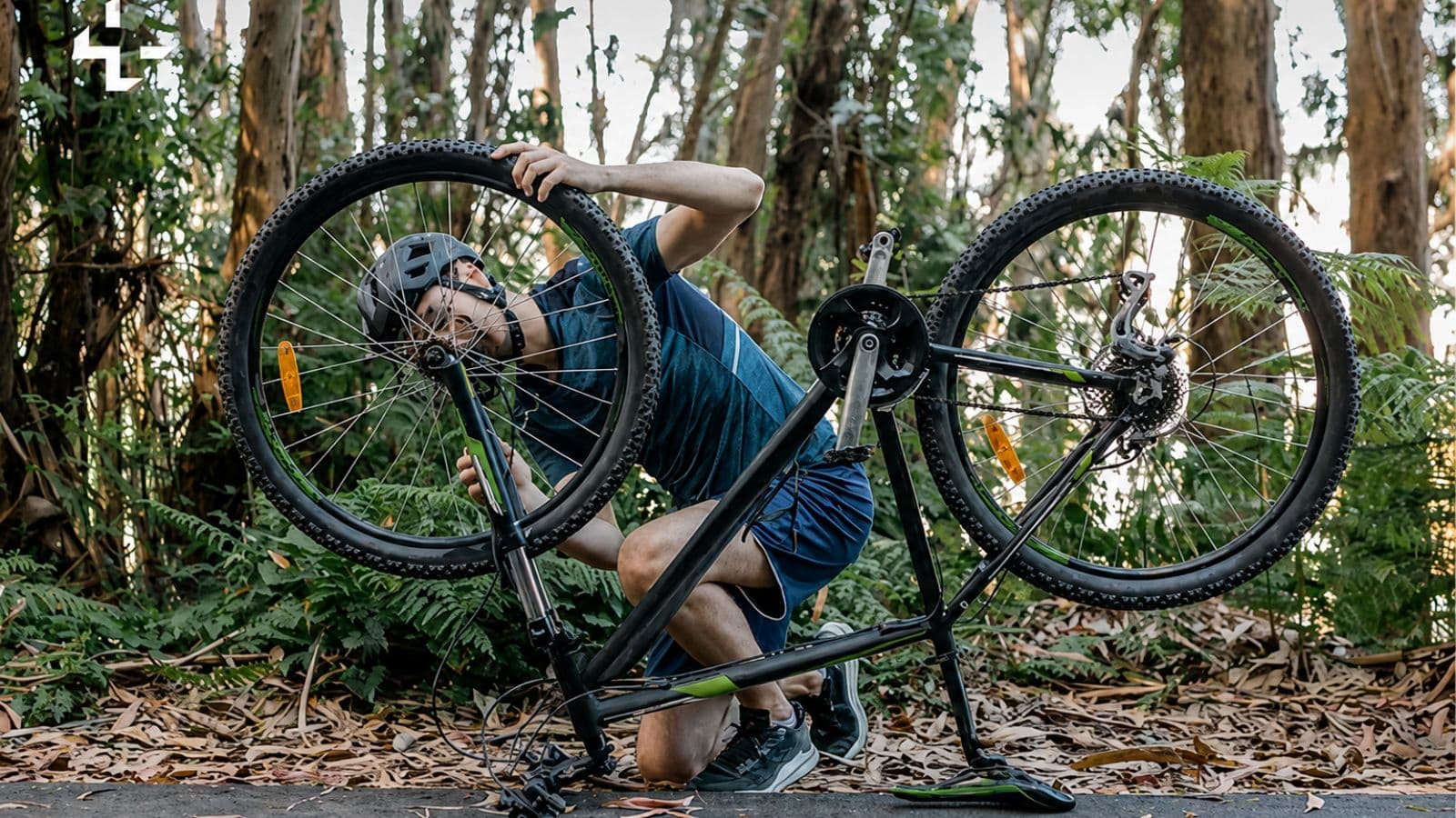 cyclist repairing punctured road bike tire during roadside maintenance stop