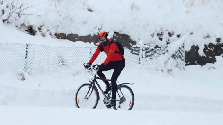 road cyclist wearing thermal clothing during cold weather ride on winter roads