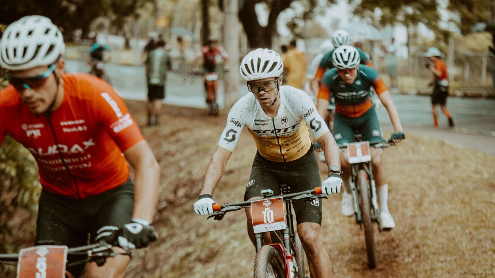 Road cyclist completing sustained lactate threshold intervals during a structured outdoor cycling workout.