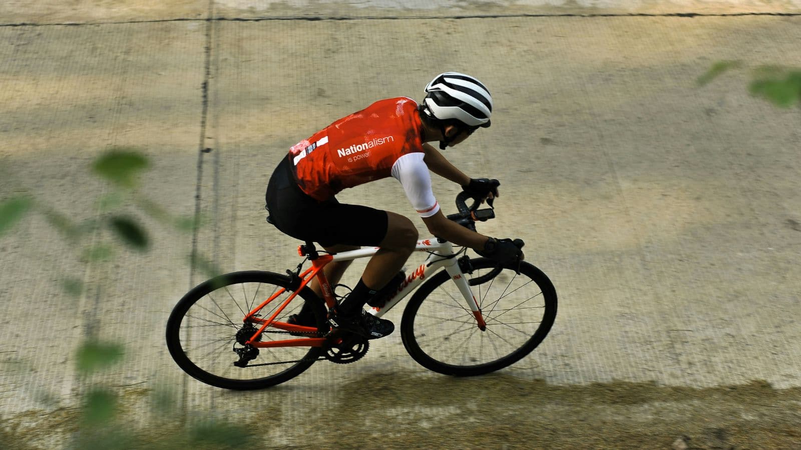 Road cyclist completing a high-intensity interval session to prepare for a short-distance cycling race.