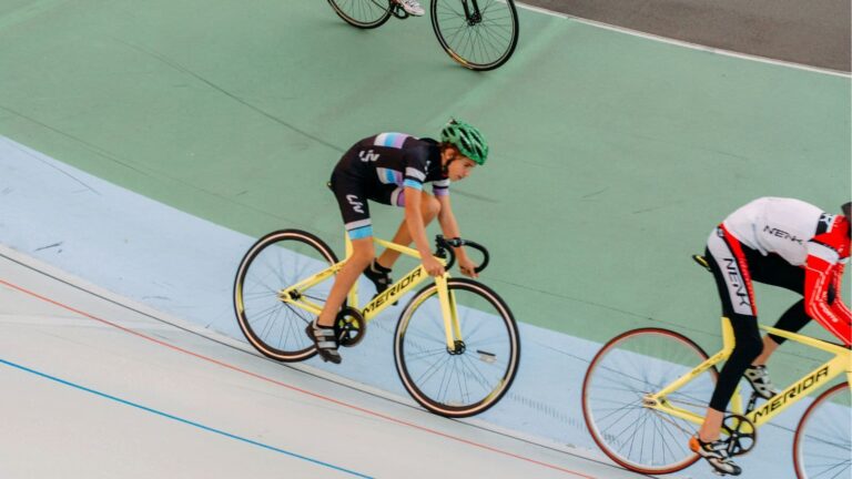 Cyclist performing a structured lactate threshold workout on an indoor smart trainer while monitoring training intensity.