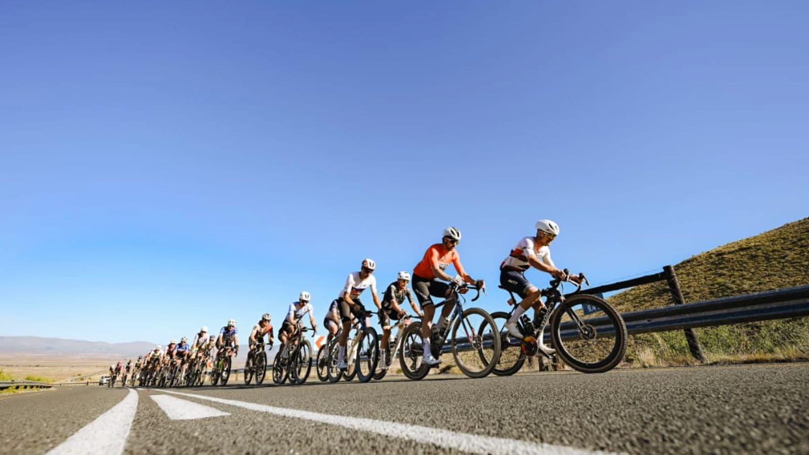Road cyclist completing a steady endurance ride on quiet country roads to develop aerobic fitness for cycling.