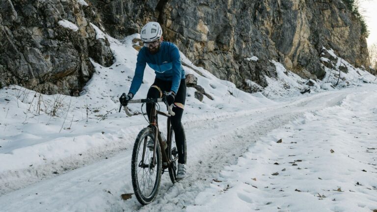 road cyclist practicing cornering and braking on damp winter roads during training ride