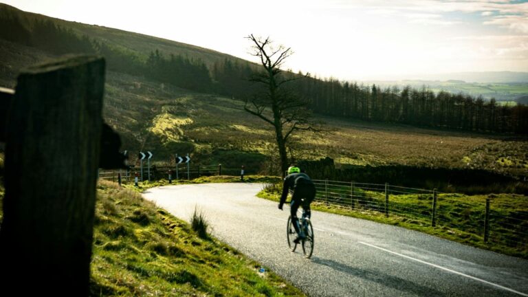cyclist training on flat roads to prepare for hilly cycling race using structured workouts