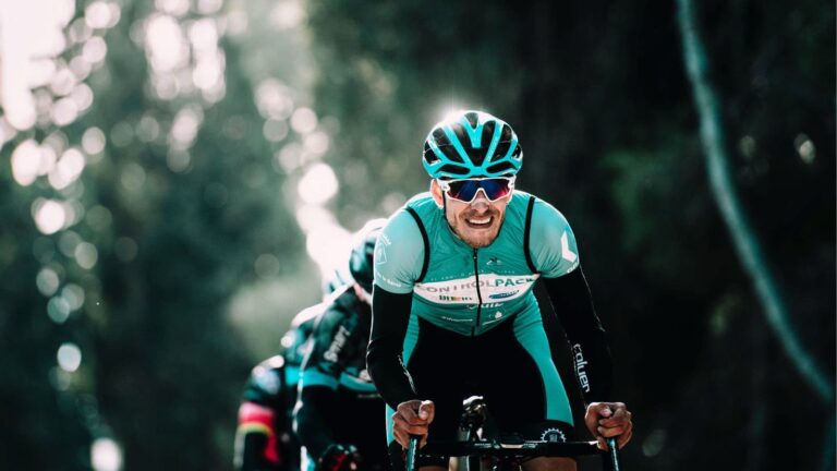 Road cyclist riding on a scenic country road during a long endurance training session for a gran fondo or endurance race.