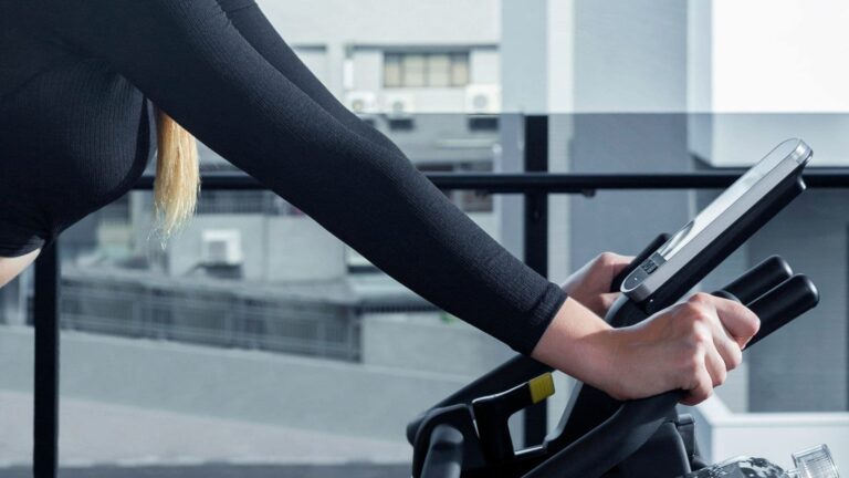 road cyclist riding indoor trainer during one hour structured interval workout to improve cycling fitness