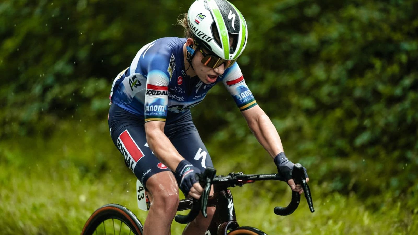 Road cyclist experiencing knee discomfort during a training ride but continuing to cycle despite persistent pain.
