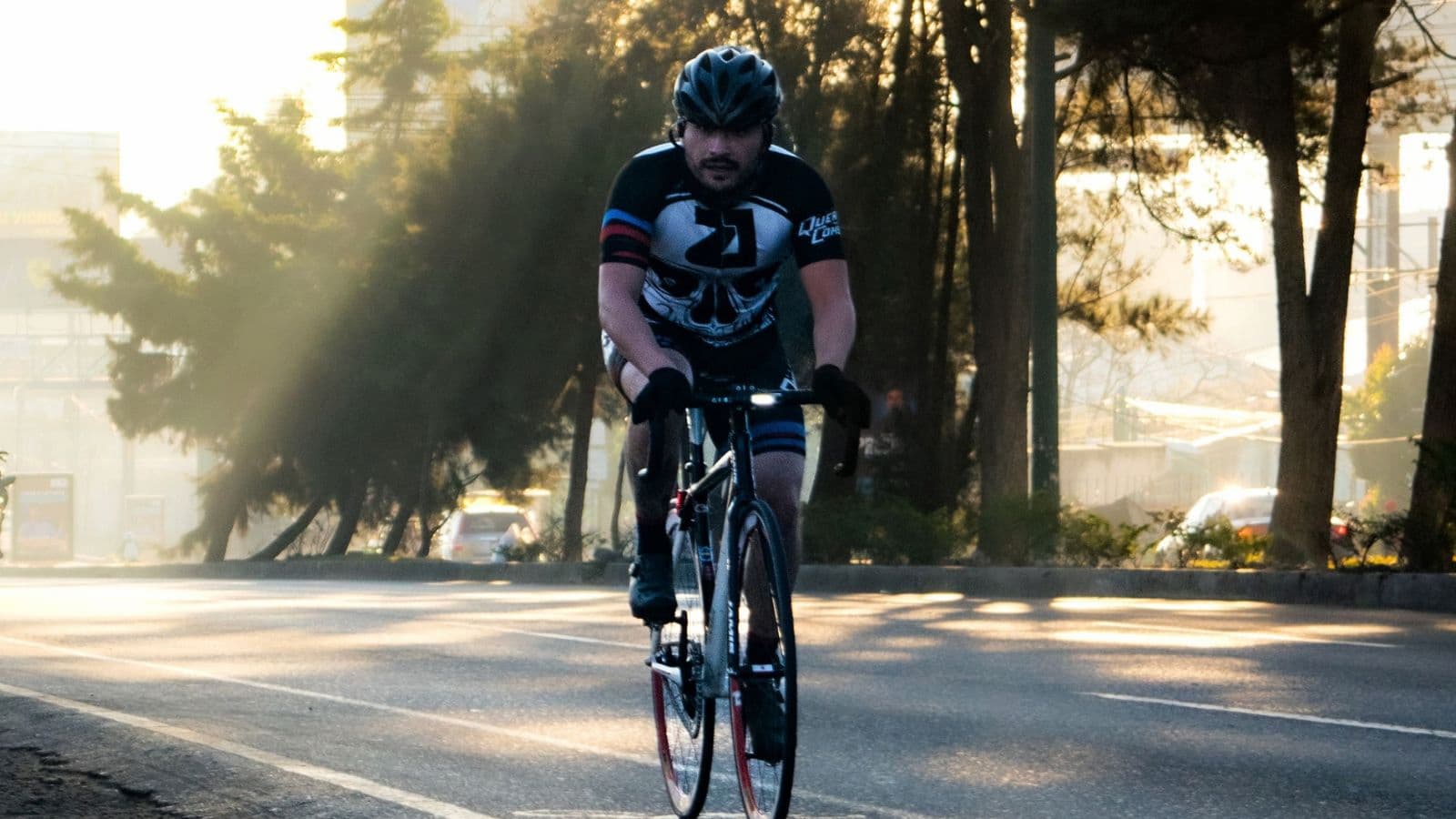 Road cyclist completing a high-intensity cycling workout in the afternoon while maintaining a strong, controlled effort.